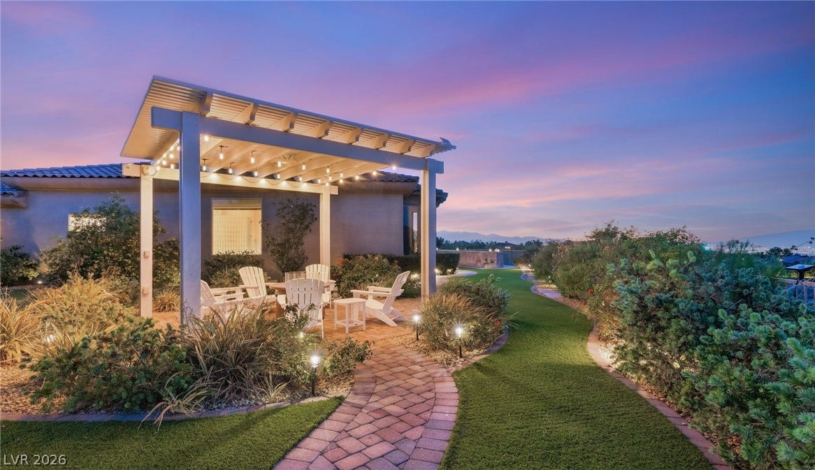 6 Brookridge Drive, Henderson, NV 89052 A stone pathway leads to an elegant patio pergola overlooking manicured grounds and distant hills.