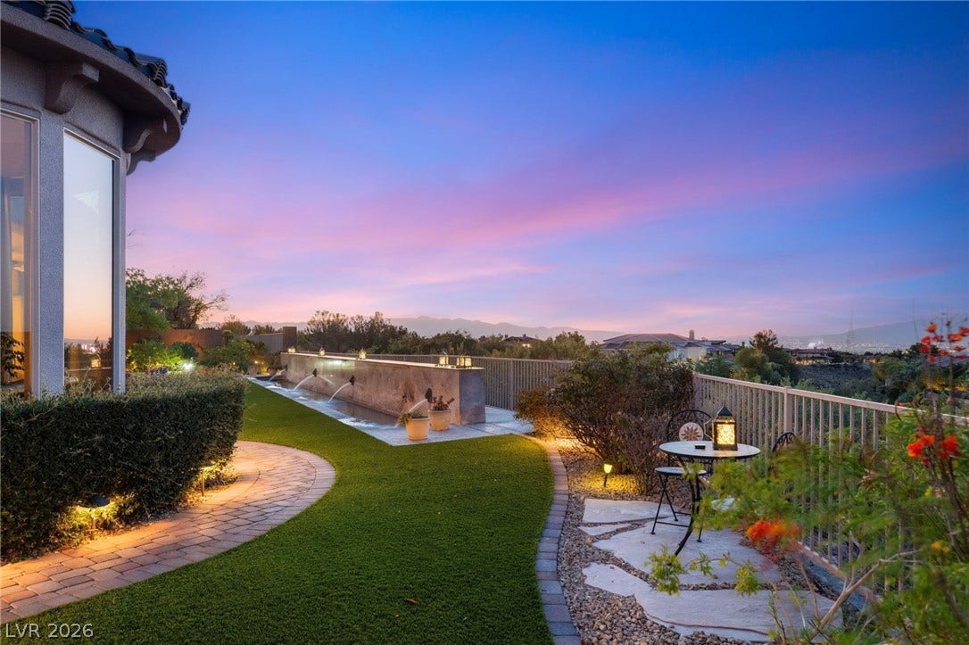 6 Brookridge Drive, Henderson, NV 89052 Lush manicured turf and a stone pathway lead to an elevated terrace overlooking distant mountains.
