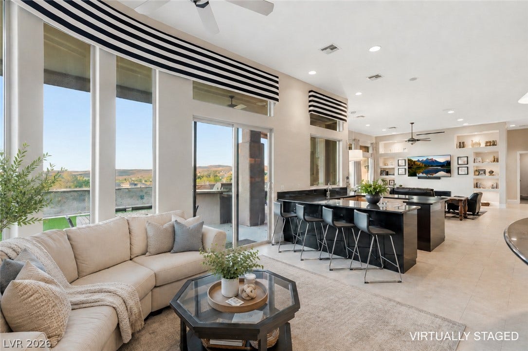 6 Brookridge Drive, Henderson, NV 89052 Towering windows frame distant mountain ridges, illuminating a vast, seamless living space.