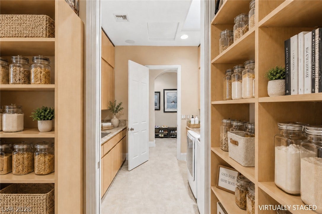 6 Brookridge Drive, Henderson, NV 89052 Ample built-in storage and tile flooring define this highly functional walk-in pantry and laundry zone.