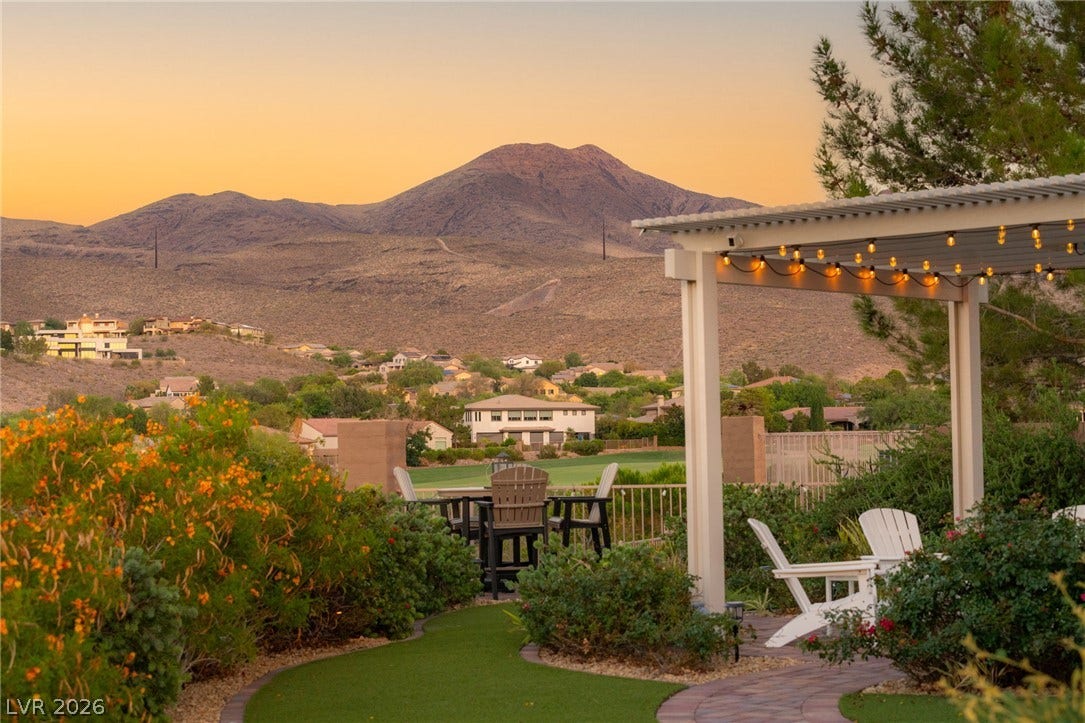 6 Brookridge Drive, Henderson, NV 89052 Dramatic mountain vistas frame the manicured yard and covered patio during sunset.