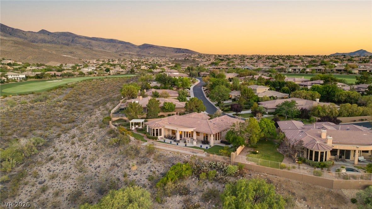 6 Brookridge Drive, Henderson, NV 89052 Dramatic mountain vistas frame this desert hillside estate nestled along the winding neighborhood streets.