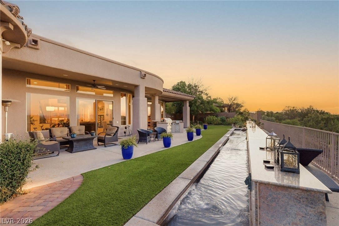 6 Brookridge Drive, Henderson, NV 89052 A long water feature and spacious concrete patio highlight this expansive outdoor living area.