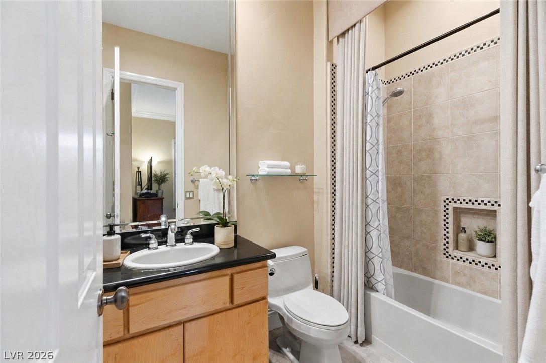 6 Brookridge Drive, Henderson, NV 89052 Tiled shower walls and stone counters highlight this well-appointed bathroom.