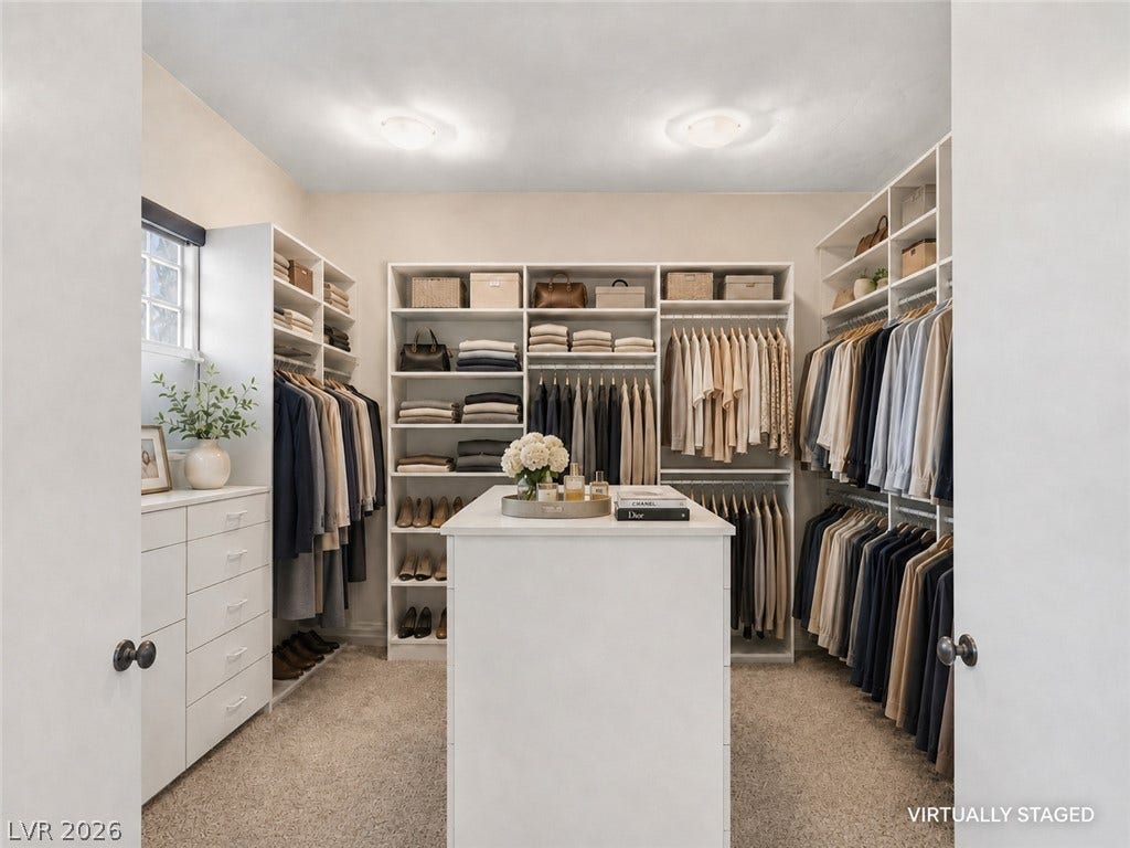 6 Brookridge Drive, Henderson, NV 89052 A spacious walk-in closet highlights carpeted flooring and custom built-in organization around a central island.