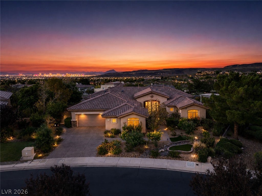 6 Brookridge Drive, Henderson, NV 89052 Distant city skyline views frame this elegant estate set against a dramatic desert sunset.