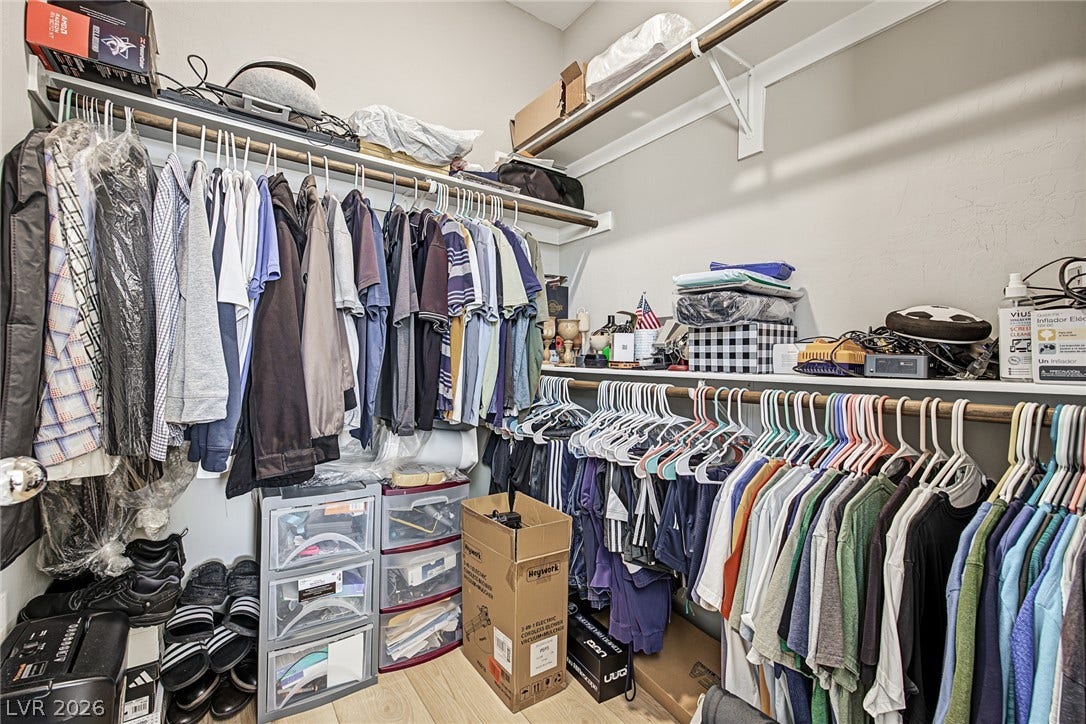 3813 Birch River Street, North Las Vegas, NV 89032 A spacious closet configuration utilizes built-in shelving and multi-tier hanging rods over light wood-look flooring.