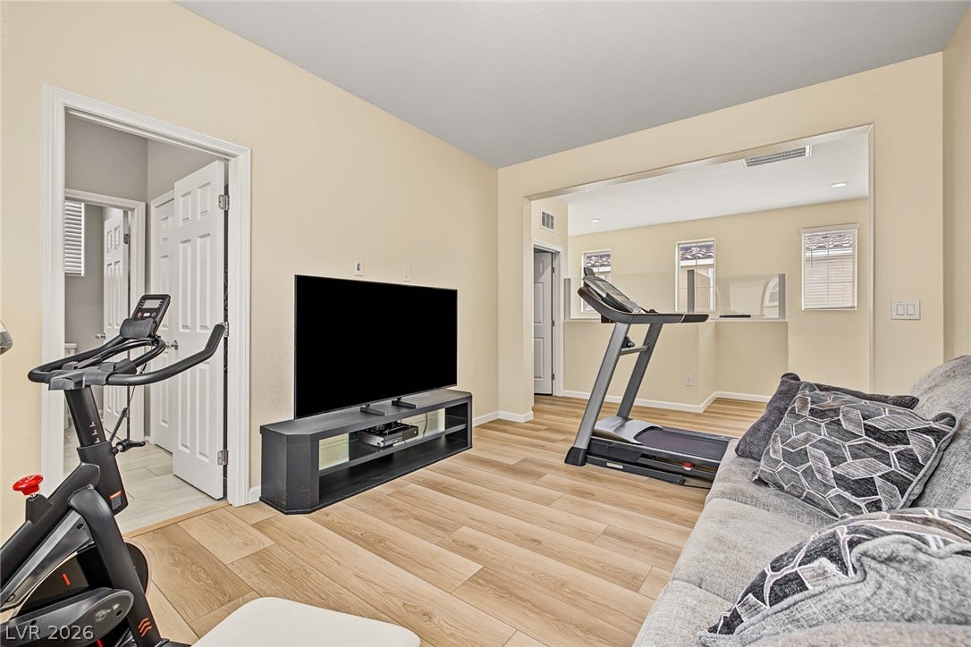 3813 Birch River Street, North Las Vegas, NV 89032 Smooth wood-style flooring and neutral walls define this versatile media and recreation space.