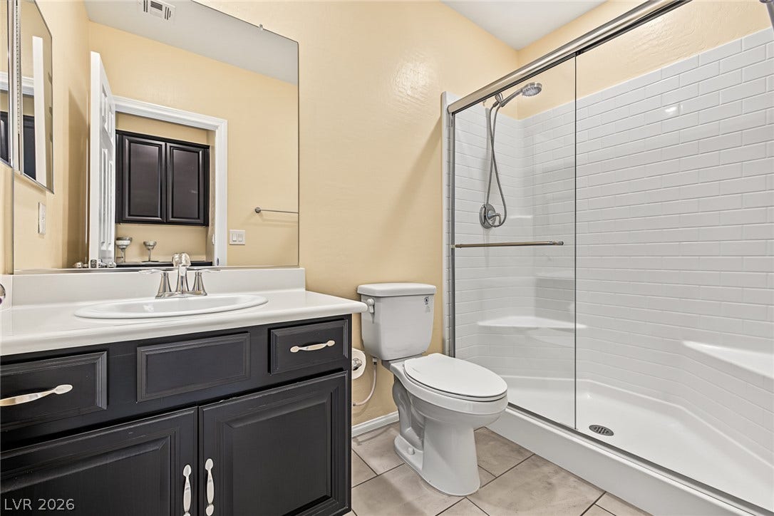 3813 Birch River Street, North Las Vegas, NV 89032 An elegant walk-in shower with classic tile accents highlights this well-appointed bathroom.