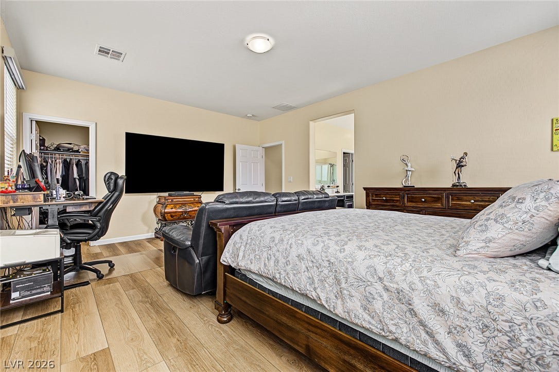 3813 Birch River Street, North Las Vegas, NV 89032 Smooth wood floors and neutral-toned walls create a relaxing atmosphere in this spacious bedroom.