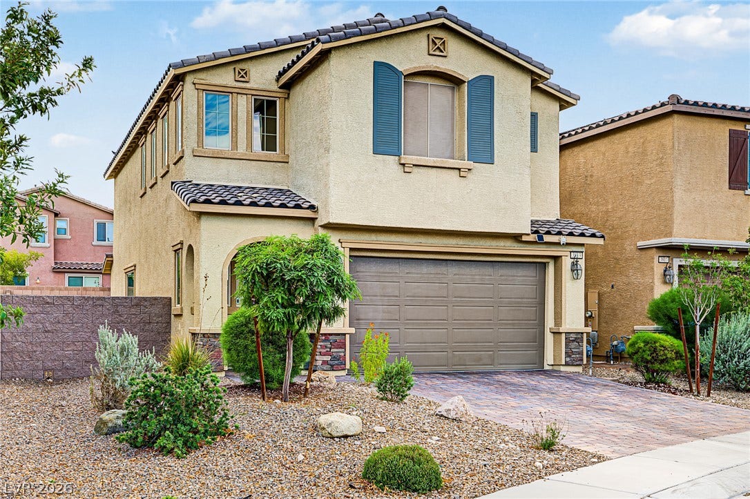 3813 Birch River Street, North Las Vegas, NV 89032 Stone accents and decorative shutters enhance the exterior of this two-story stucco home.