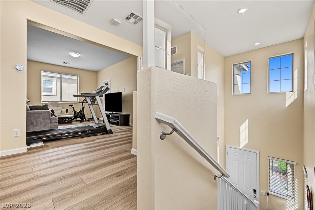 3813 Birch River Street, North Las Vegas, NV 89032 An open stairwell leads past tall windows and directly into a versatile upstairs landing.