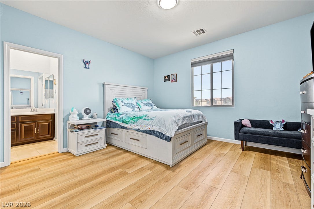 3813 Birch River Street, North Las Vegas, NV 89032 Gleaming wood floors and a wide window define this comfortable, light-filled bedroom suite.