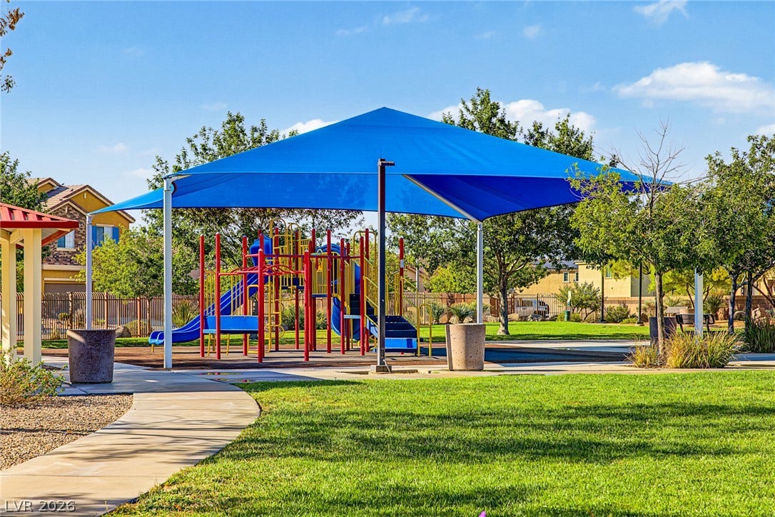 3813 Birch River Street, North Las Vegas, NV 89032 A shaded playground structure sits adjacent to manicured lawns and concrete walking paths.