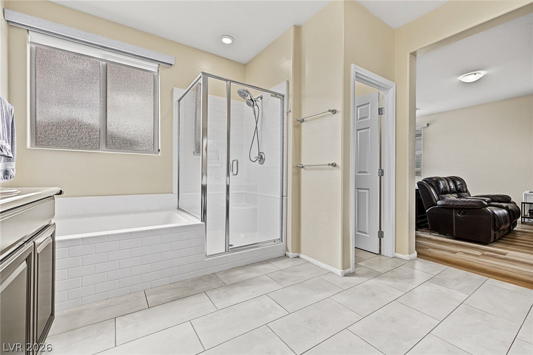 3813 Birch River Street, North Las Vegas, NV 89032 Tiled flooring and a separate glass-enclosed shower create a functional bathroom layout.