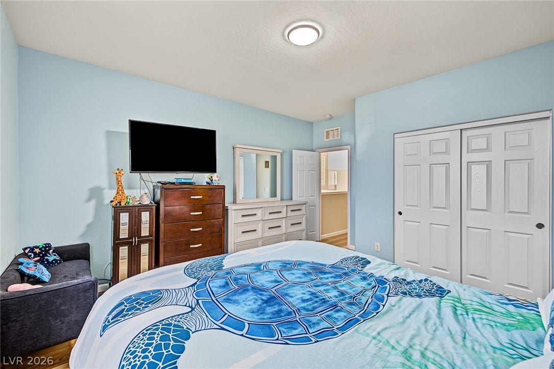 3813 Birch River Street, North Las Vegas, NV 89032 Smooth plaster walls and warm wood flooring define this comfortable bedroom space.