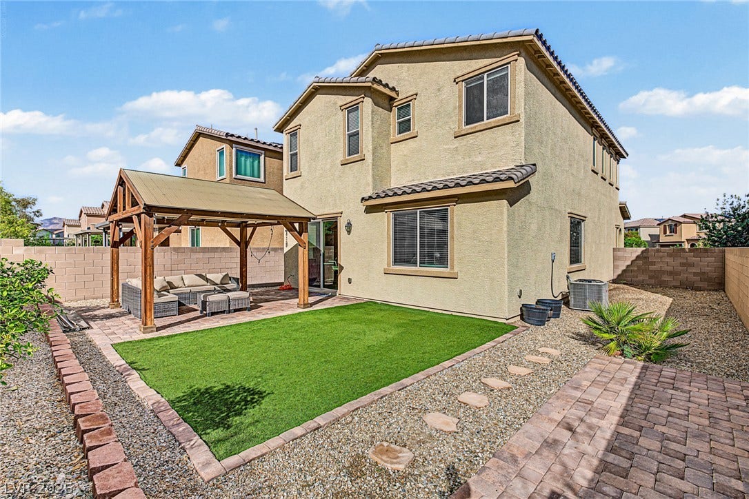 3813 Birch River Street, North Las Vegas, NV 89032 A spacious backyard features a structured covered pavilion alongside low-maintenance synthetic turf.