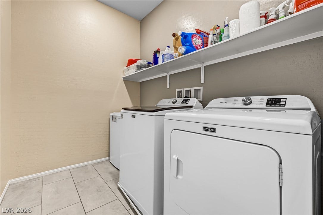 3813 Birch River Street, North Las Vegas, NV 89032 Tiled flooring and open shelving create a functional laundry space.