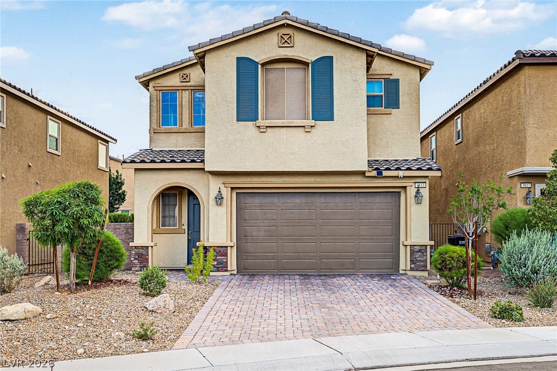 3813 Birch River Street, North Las Vegas, NV 89032 A paved driveway leads to the integrated garage of this stucco-clad two-story home.