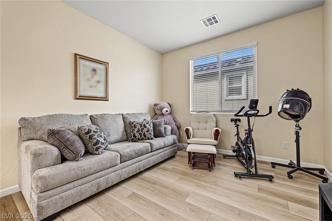 3813 Birch River Street, North Las Vegas, NV 89032 Smooth wood-plank flooring and a bright window define this versatile secondary living space.