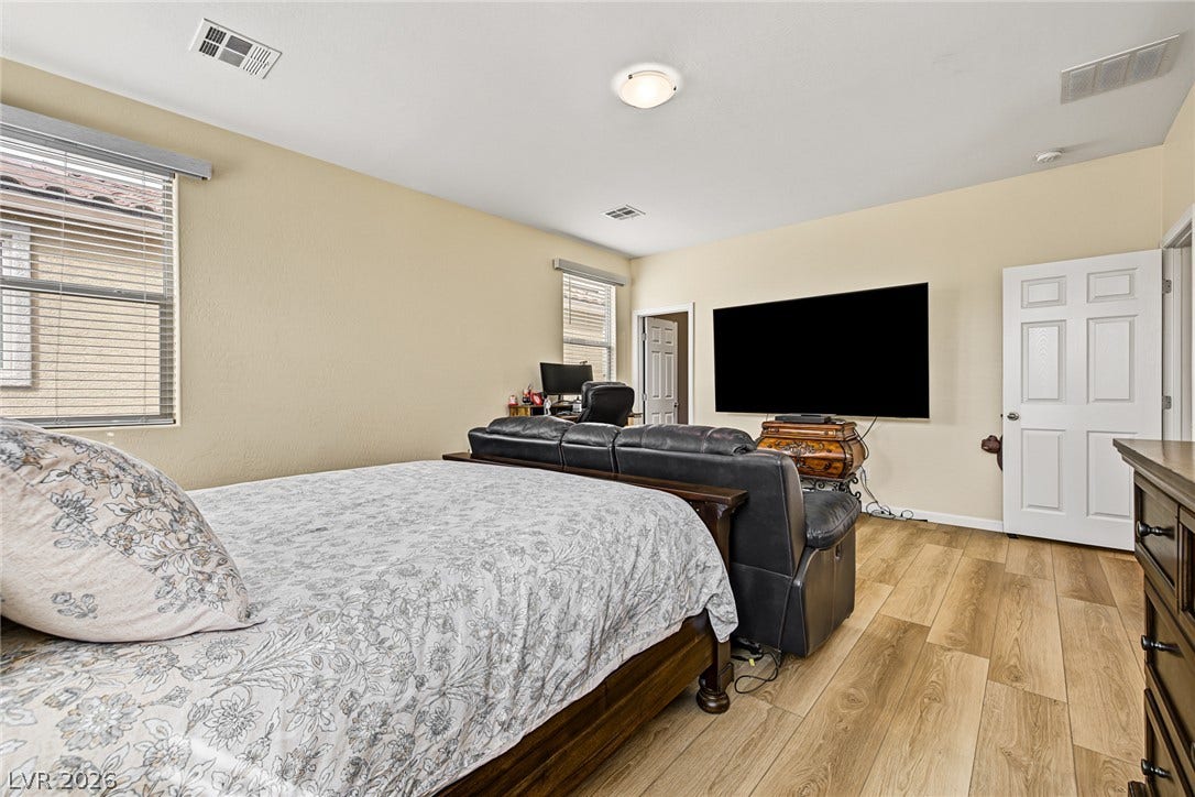3813 Birch River Street, North Las Vegas, NV 89032 Warm wood floors and multiple windows define this versatile bedroom layout.