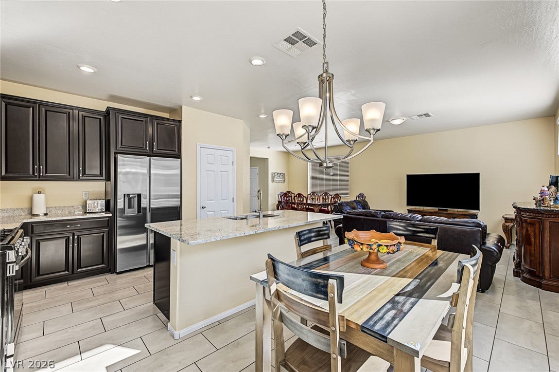 3813 Birch River Street, North Las Vegas, NV 89032 An open floor plan seamlessly connects the kitchen to the dining and living spaces.