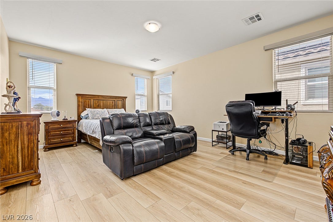 3813 Birch River Street, North Las Vegas, NV 89032 Smooth wood-look flooring and multiple windows enhance this multi-functional secondary bedroom.
