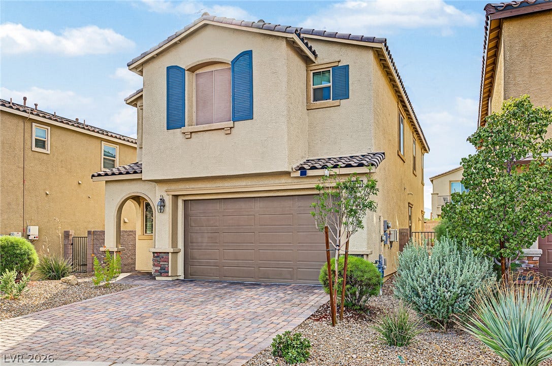 3813 Birch River Street, North Las Vegas, NV 89032 An inviting two-story stucco exterior features a paver driveway, detailed stonework, and tiled rooflines.