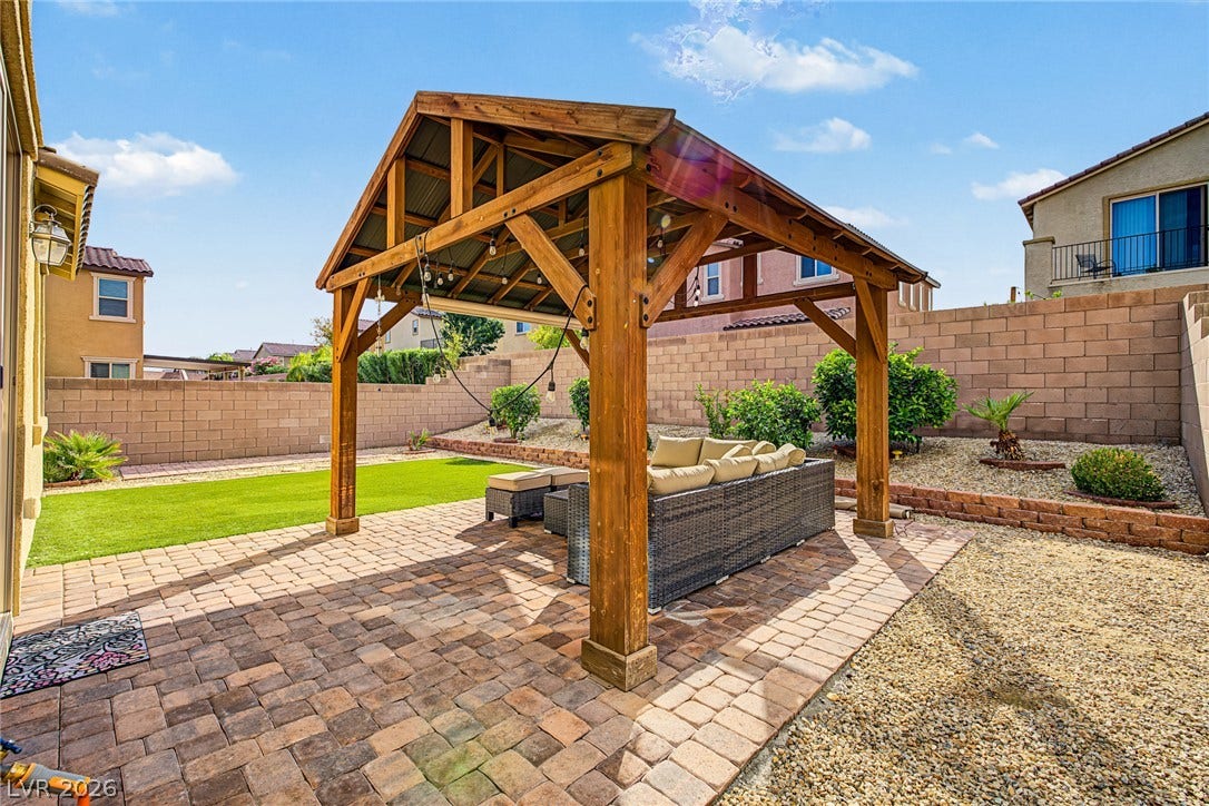 3813 Birch River Street, North Las Vegas, NV 89032 An inviting backyard oasis features a substantial timber pavilion over a paved patio.