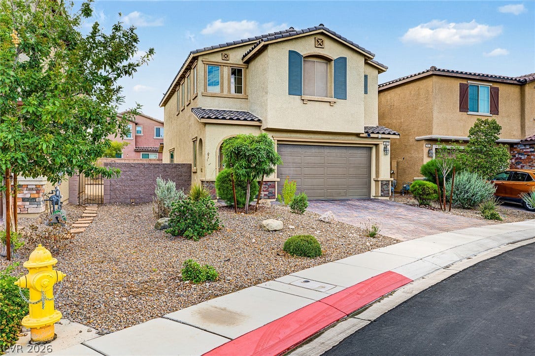 3813 Birch River Street, North Las Vegas, NV 89032 Desert landscaping and a paved driveway enhance the stucco exterior of this multi-level home.