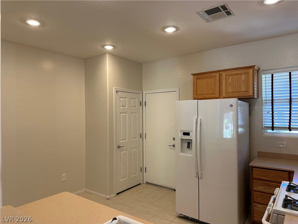 2488 Galaxy Cluster Street, Henderson, NV 89044 Kitchen boasts Corian Counters, Upgraded Cabinets, Nook, Recessed Lighting, Pantry, Tile Flooring, Gas Stove, Dishwasher, Microwave, and Refrigerator