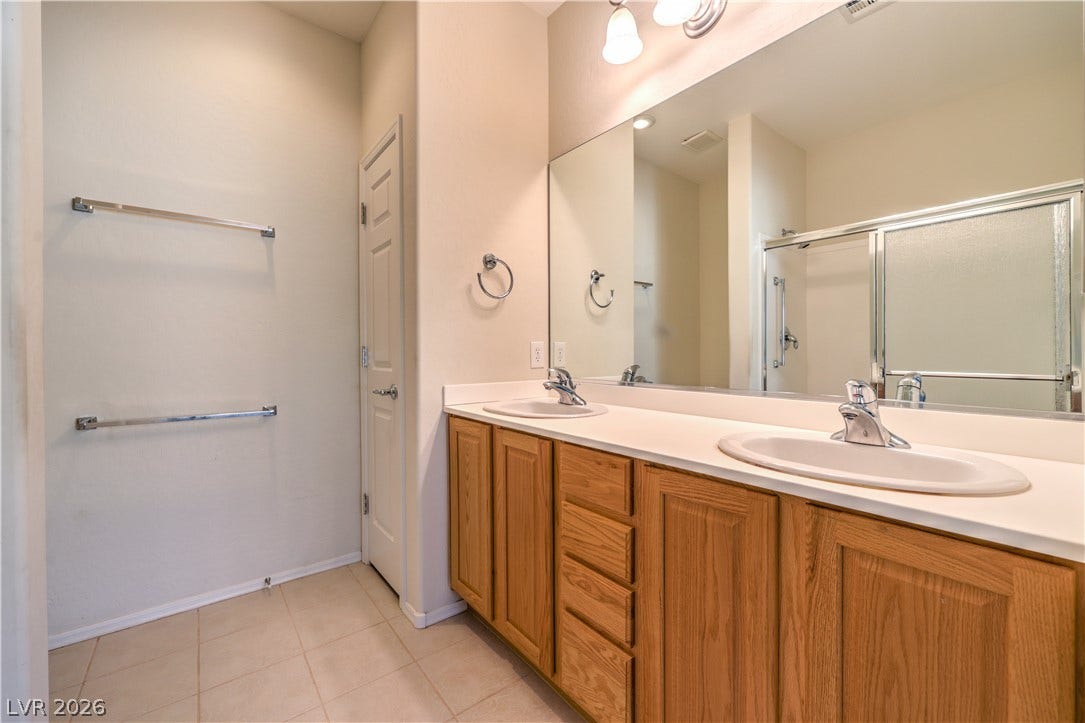 2488 Galaxy Cluster Street, Henderson, NV 89044 Owners Bathroom with Dual Sinks, Shower, Linen Closet, and Tile Flooring
