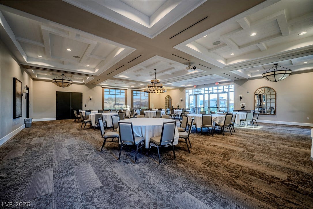 Elaborate coffered ceilings and patterned carpeting define this expansive multi-purpose gathering space.