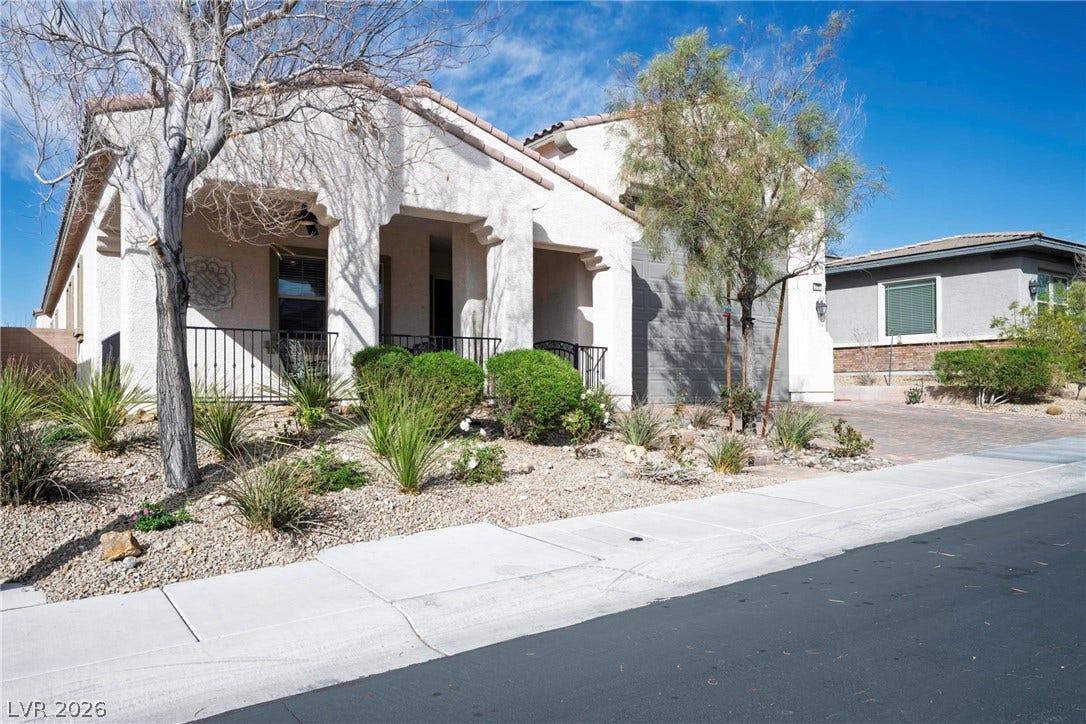 Desert landscaping and stucco finishes define this southwest-inspired exterior design.