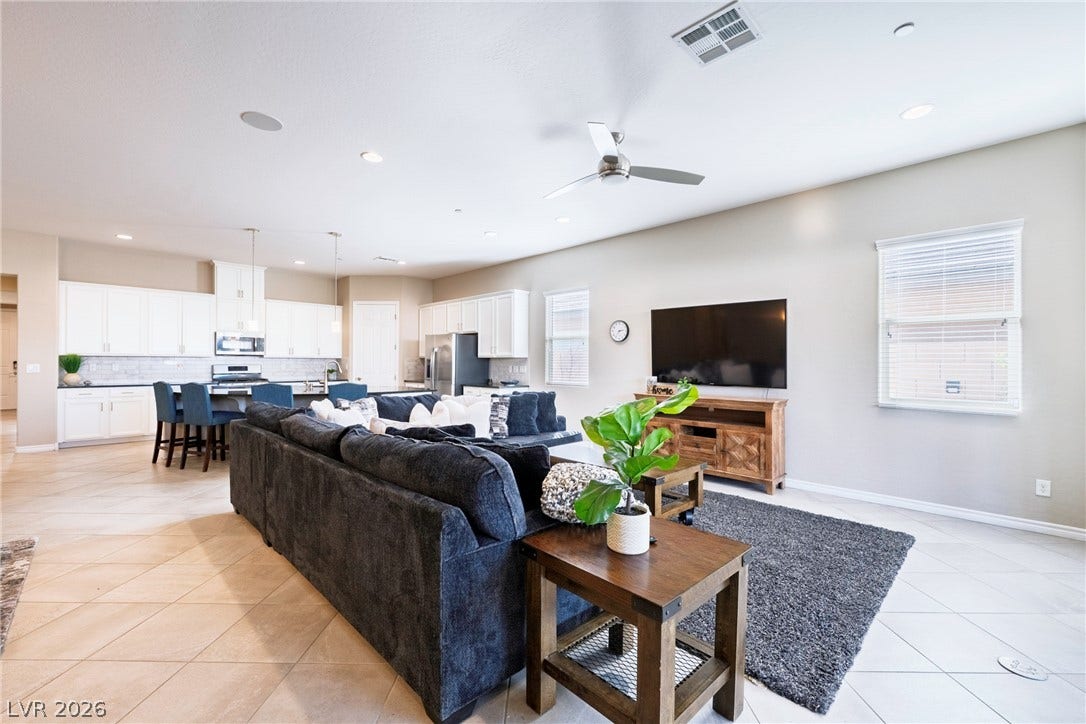 An open floor plan seamlessly connects the central living area with the adjacent kitchen.