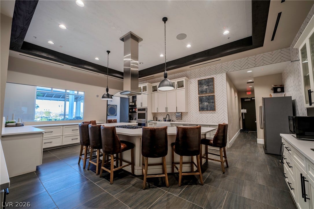 High ceilings, tiled flooring, and premium finishes anchor this custom kitchen space.