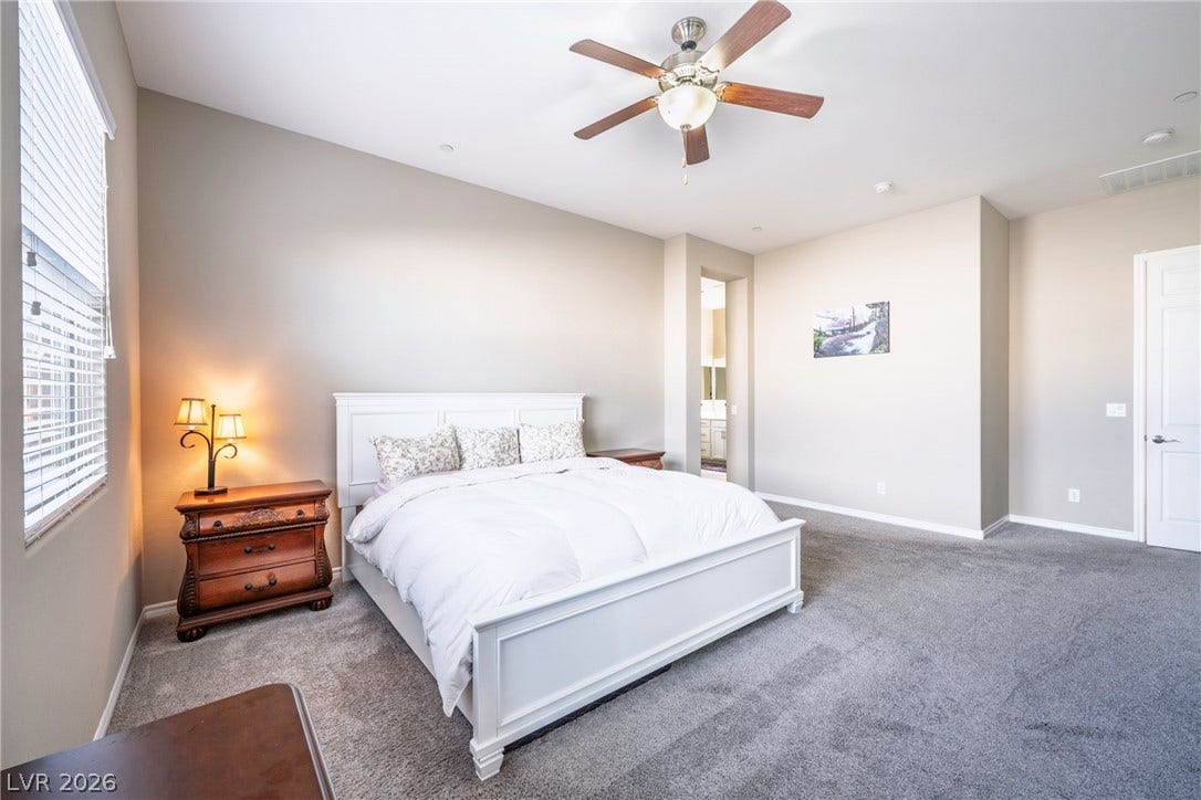 Generous proportions and soft carpeting define this comfortable primary bedroom suite.