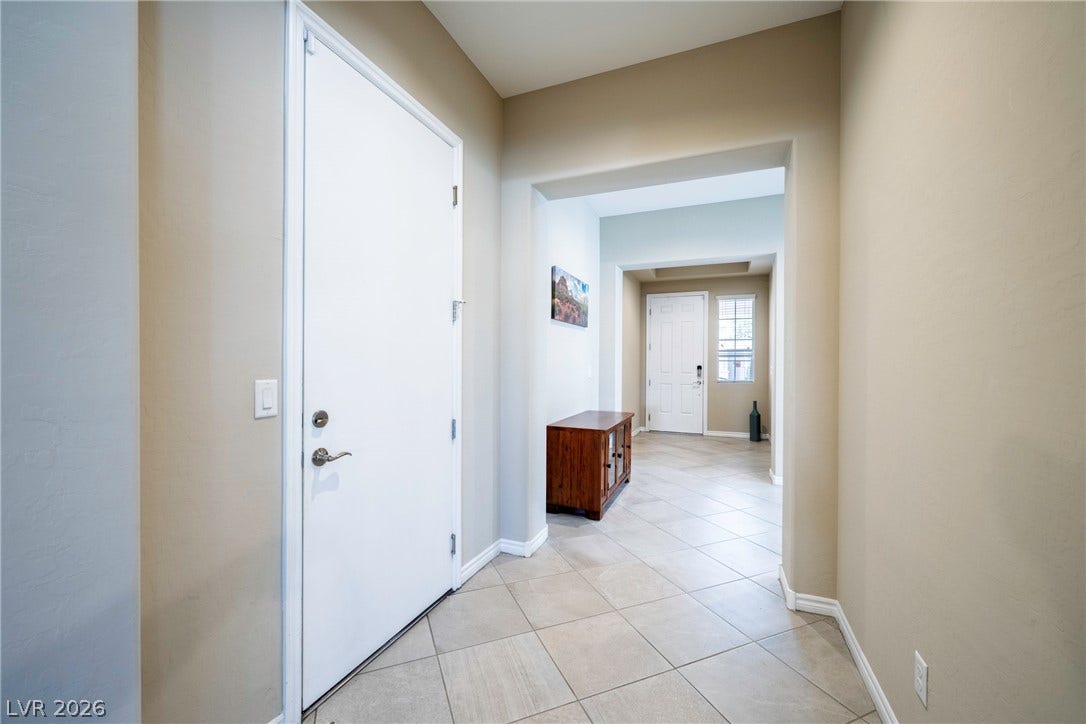 Tiled flooring and high ceilings define this welcoming entryway.