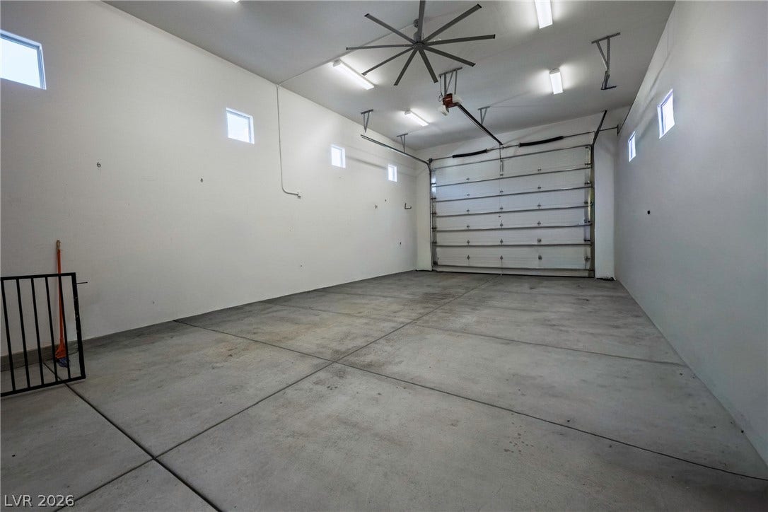 An oversized garage provides soaring ceilings and a durable concrete floor.