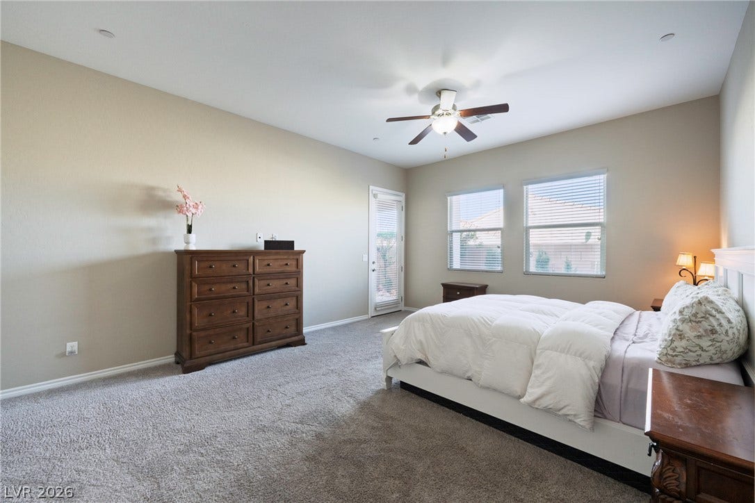 A private door accesses the outdoors from this plushly carpeted bedroom suite.