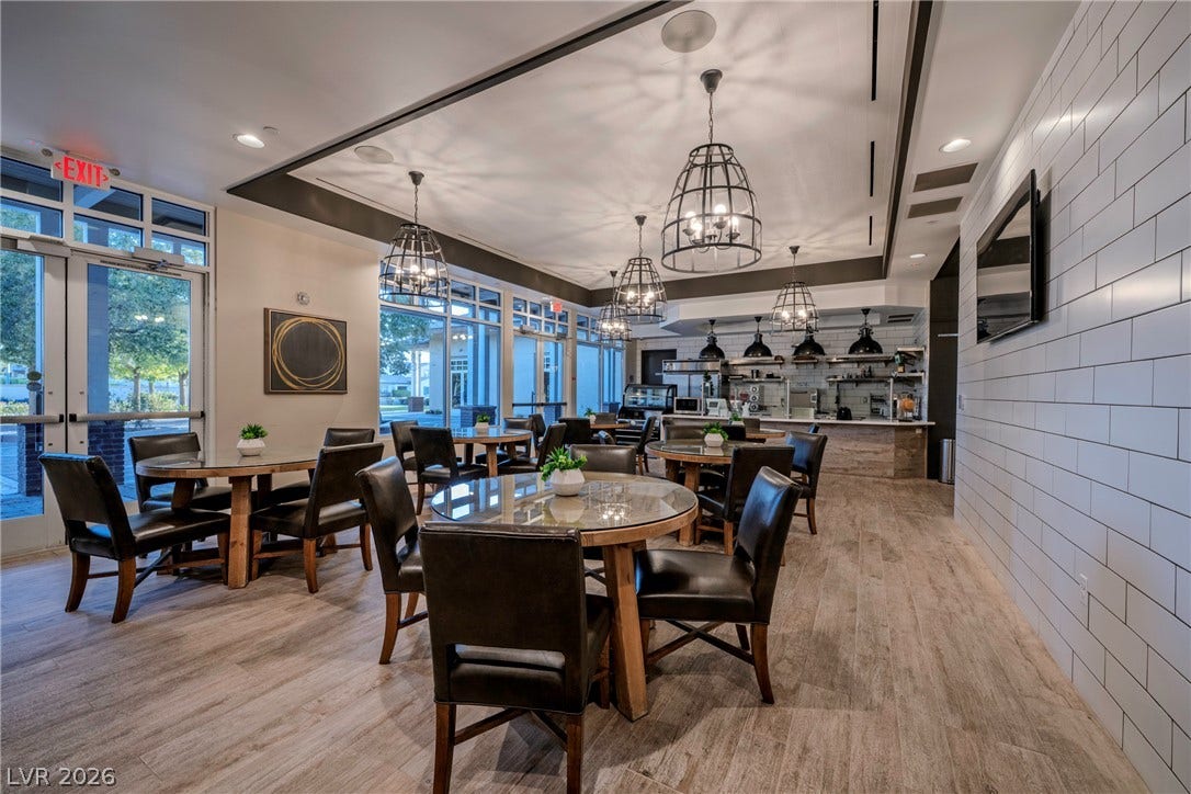 Plentiful glass doors and recessed lighting illuminate this welcoming common dining space.