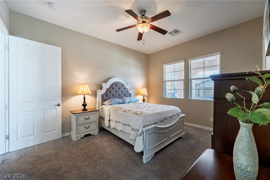 Plush carpeting and abundant natural light define this cozy and comfortable secondary bedroom.