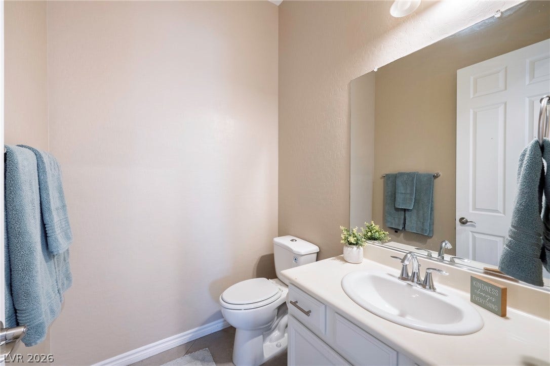 An elegant single-sink vanity complements the clean lines of this updated powder room.