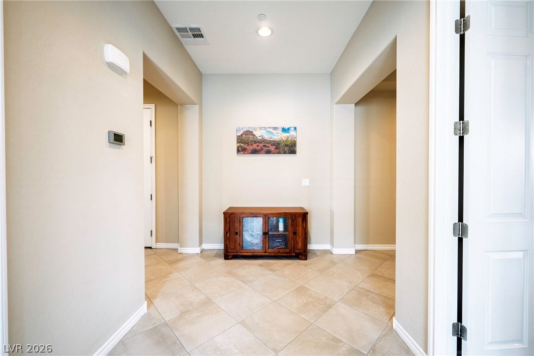 Clean lines and durable tile flooring define this welcoming home entrance.