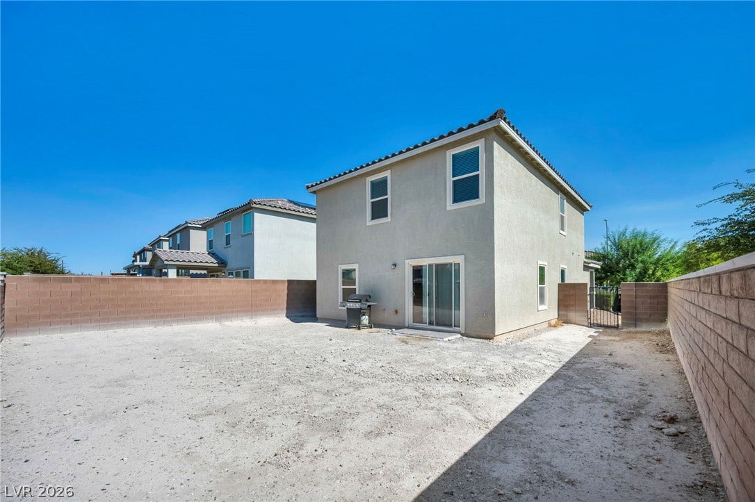 1205 Deep Valley Avenue, North Las Vegas, NV 89084 A spacious backyard enclosed by durable block fencing awaits your personal landscaping vision.