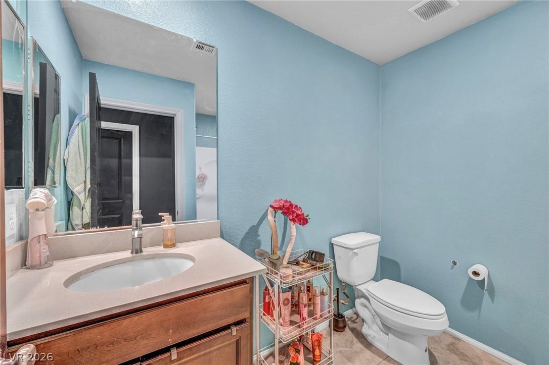 1205 Deep Valley Avenue, North Las Vegas, NV 89084 Clean lines and stone-look tile flooring define this classic powder room.