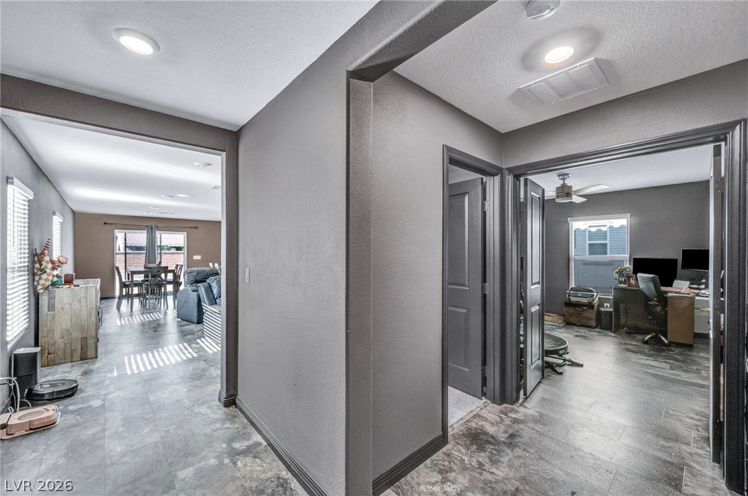 1205 Deep Valley Avenue, North Las Vegas, NV 89084 A wide doorway connects the central hallway to the open living spaces.