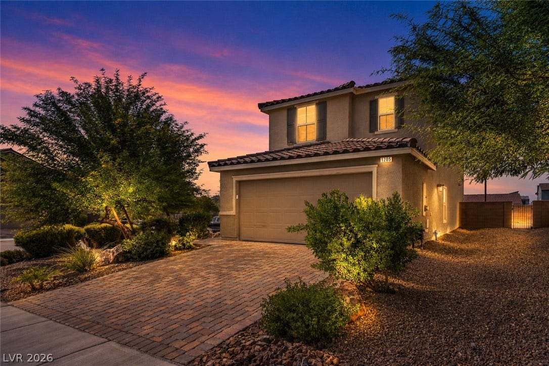 1205 Deep Valley Avenue, North Las Vegas, NV 89084 Lush desert landscaping and a paved driveway welcome you to this two-story stucco home.