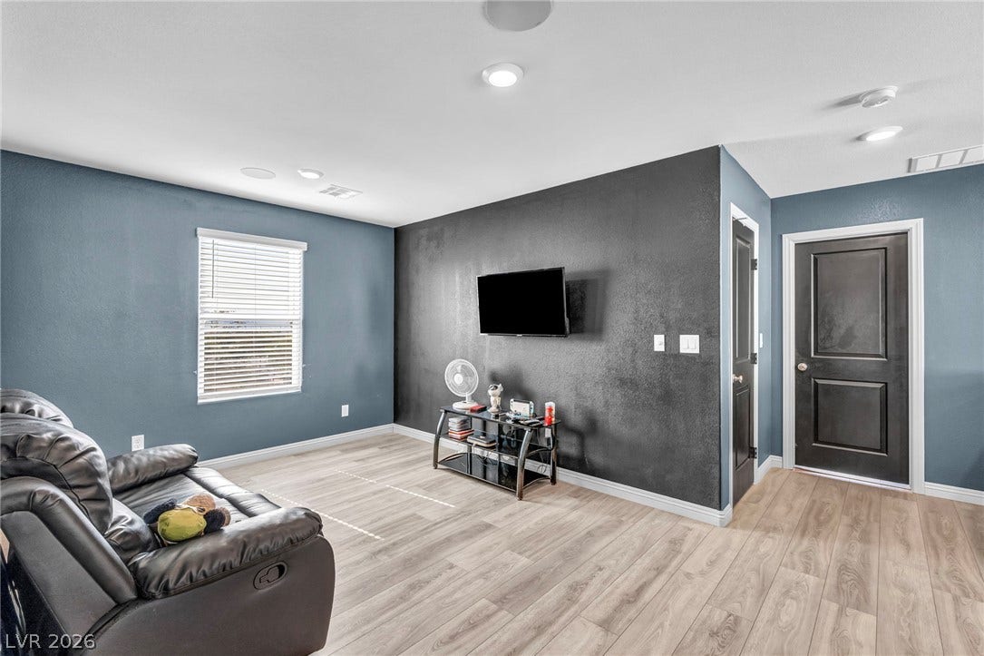 1205 Deep Valley Avenue, North Las Vegas, NV 89084 Smooth wood-look flooring and crisp recessed lighting define this versatile living space.