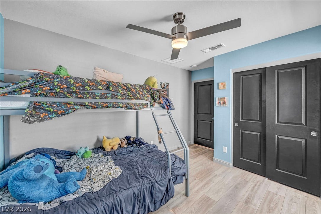 1205 Deep Valley Avenue, North Las Vegas, NV 89084 Smooth wood-look flooring and a modern ceiling fan anchor this versatile secondary bedroom.